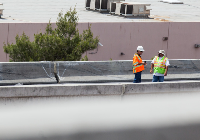 Officials from the Nevada Department of Transportation and Nevada Highway Patrol investigate possible damage on the ramp from southbound U.S. Route 95 to southbound Interstate 15 on Friday, May 22 ...