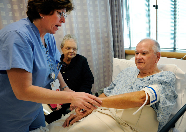 Registered nurse Judine Dougherty, left, verifies Gerald Bye identity, as his wife, Nancy Bye looks on in the pre-op area before his radio frequency ablation procedure to treat Barrett's esophagus ...