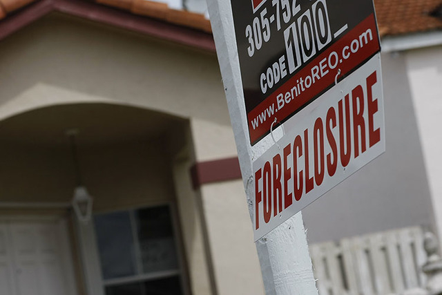A foreclosure sign hangs in front of a home. (Joe Raedle/Getty Images/Thinkstock)