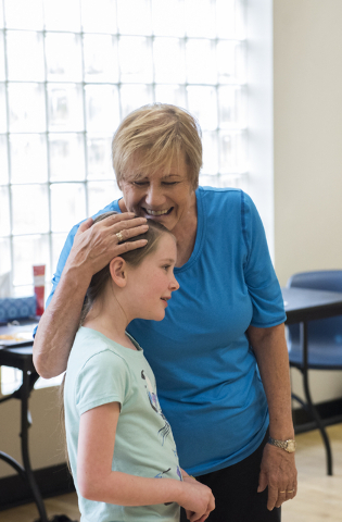 Dance instructor Lori Day, top, embraces student Alaina Michaelson, 8, during tap dance class at the Whitney Ranch Recreation Center in Henderson, Nev., on Thursday, April 23, 2015. (Martin S. Fue ...