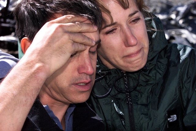 Steve Peterso, left, and Brenda Cummings cling to each other during a memorial service on Aug. 4, 2001, held at the site of the 1955 Air Force C-54 transport plane crash near Mt. Charleston peak t ...