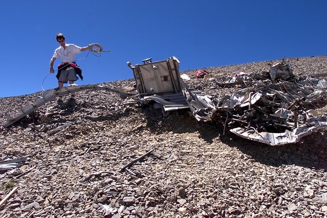 Eric Christiansen works amid the debris of the Air Force C-54 transport plane on Aug. 4, 2001, that crashed near the Mount Charleston summit in 1955. This during the Silent Heroes of the Cold War  ...