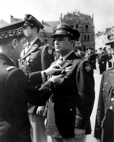 A French officer pins the Croix de Guerre [Cross of War] on U.S. Army Air Corps Lt. Col. Howard Cannon, during an award ceremony, sometime after VE Day [Victory Europe] in 1945. Cannon, who served ...