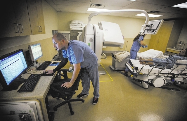 Nuclear medical technologist Bobby Levie views files after conducting a  cardio stress test on Faija Douglas at Sunrise Hospital & Medical Center,  3186 S Maryland Parkway, on Thursday, May 14, 201 …