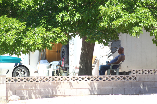 A nearby resident watches as Las Vegas police investigate an officer-involved shooting on the 6300 block of Blue Jay Way, near Oakey and Jones boulevards in Las Vegas on Wednesday, April 29, 2015. ...