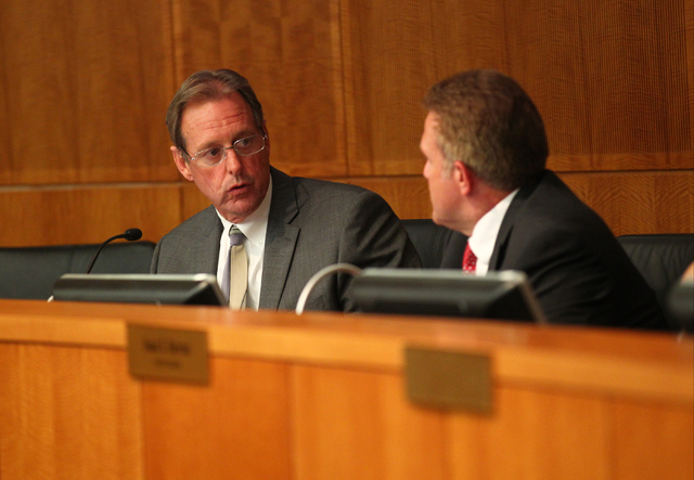 North Las Vegas Mayor John Lee, left, speaks with Councilman Wade Wagner during an agenda item about the possibility of the city outsourcing it's human resources department to a third party during ...