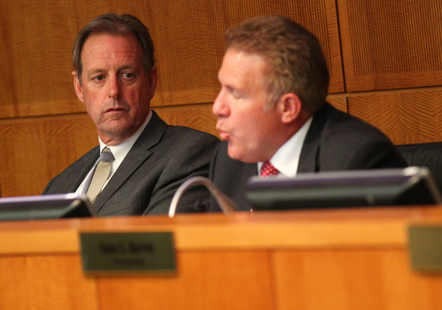 North Las Vegas Mayor John Lee, left, listens as Councilman Wade Wagner speaks during an agenda item about the possibility of the city outsourcing it's human resources department to a third party  ...