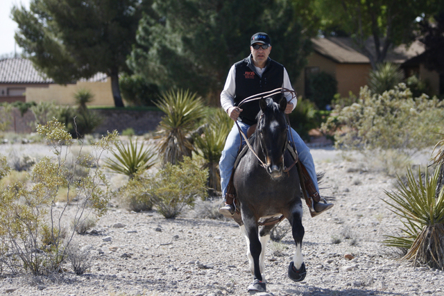 Peter Filiberti, a resident in the northwest Centennial Hills community, rides his horse to his home near the intersection of Bright Angel Way and Eula Street in Las Vegas Thursday, May 7, 2015. N ...