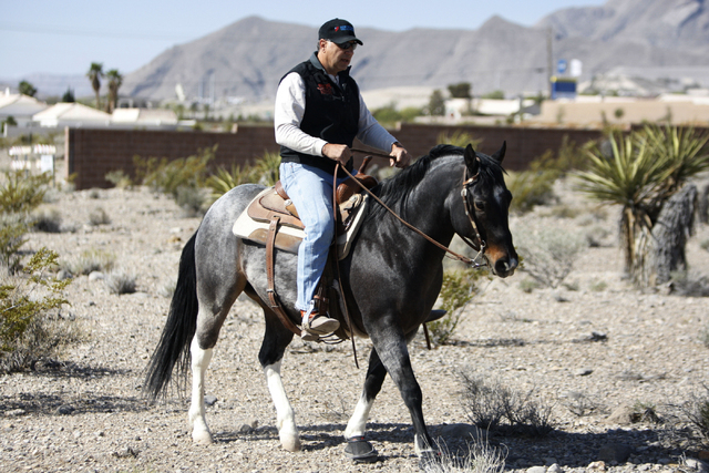 Peter Filiberti, a resident in the northwest Centennial Hills community, rides his horse to his home near the intersection of Bright Angel Way and Eula Street in Las Vegas Thursday, May 7, 2015. N ...