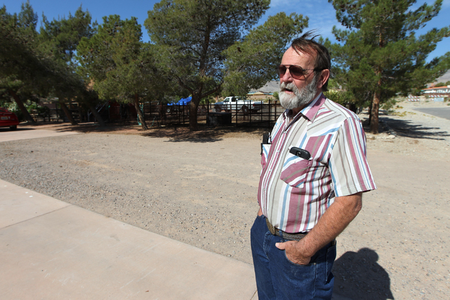 Bruce Lahman, a resident in the northwest Centennial Hills community, is interviewed on a proposed housing development next to his property near the intersection of Bright Angel Way and Eula Stree ...