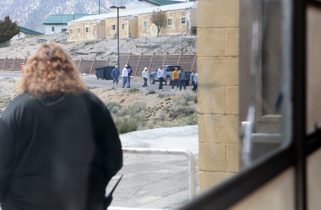 Youth at the Spring Mountain Youth Camp walk toward the gym under the watchful eye of a probation officer on Wednesday, April 22, 2015. Professional boxers and boxing referees visited the camp, wh ...