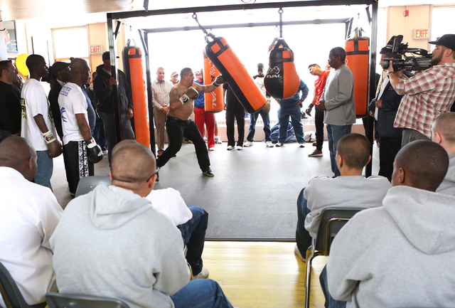 Youth watch as boxer Jessie Vargas, center, gives lessons on how to use a heavy punching bag to young boxers, left, at the Spring Mountain Youth Camp Wednesday, April 22, 2015. Professional boxers ...