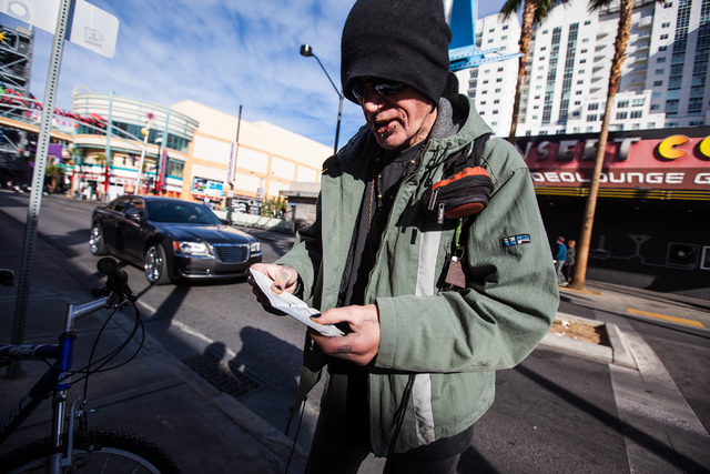 Russell Yeager looks through his itinerary for the afternoon before biking to local shops in the downtown area of Las Vegas on Friday, Jan. 16, 2015. Yeager has been living in a halfway home, wher ...
