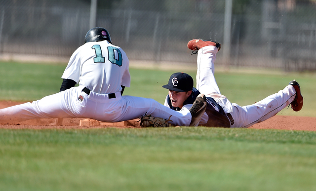 Coronado High School second baseman Anthony Olheiser dives to make the tag on Silverado's Chase Cortez during a first round game in the Sunrise Region baseball tournament at Silverado High School ...