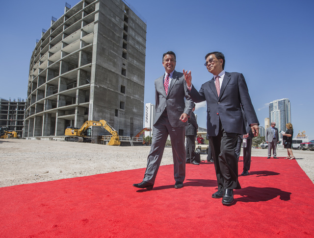 K.T. Lim, chairman,right, CEO of Genting Group, walks with Gov. Brian Sandoval during the groundbreaking of the $4 billion Resorts World Las Vegas resort property, the site of the former Stardu ...