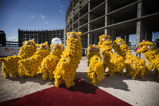 Members of the Resorts World Lion Dancers perform during the groundbreaking of the $4 billion Resorts World Las Vegas resort property, the site of the former Stardust hotel-casino on Tuesday, Ma ...