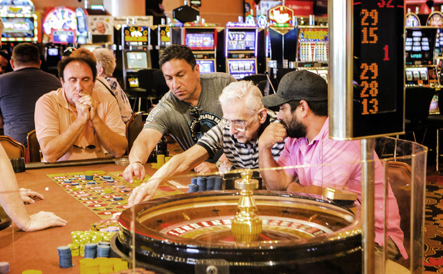 The gamblers place their bets at the roulette table at the Riviera hotel-casino, 2901 Las Vegas Blvd. South, on Monday, April 20, 2015. The 60-year-old resort will close Monday, May 4. (Jeff Schei ...