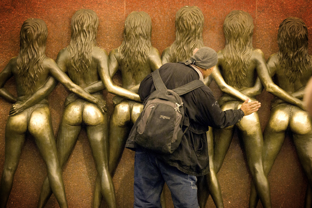 A man slaps the statue of the Crazy Girls in front of the  Riviera hotel-casino, 2901 South Las Vegas Boulevard on Monday, April 20,2015. The resort will close next Tuesday to make room for Las Ve ...