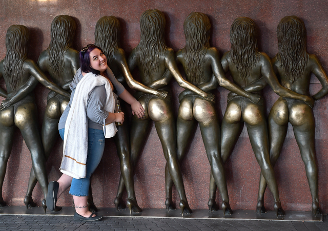 A tourist is photographed at the Crazy Girls bronze statue at the Riviera hotel-casino on Monday, March 23, 2015. The 60-year-old Strip hotel is scheduled to close on May 4. The Las Vegas Conventi ...