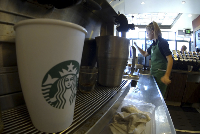 A barista makes drinks inside a newly designed Starbucks coffee shop in 2013.  (Mike Blake/Reuters)