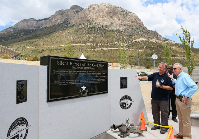 Steve Ririe, left, Silent Heroes of the Cold War committee chair, and U.S. Sen. Harry Reid, D-Nev., right, look at the Silent Heroes of the Cold War national memorial at Spring Mountains Visitor G ...