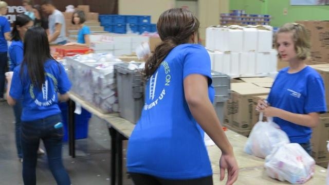 City National Bank colleagues and their families help fill bags of food May 19, 2015, at Three Square food bank. (Special to View)