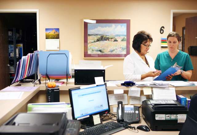 Registered nurse Agnes Escalona, left, instructs new volunteer Meghan Bell, also an R.N., at Volunteers in Medicine of Southern Nevada, 4770 Harrison Drive, in Las Vegas, Friday, Sept. 7, 2012. Th ...