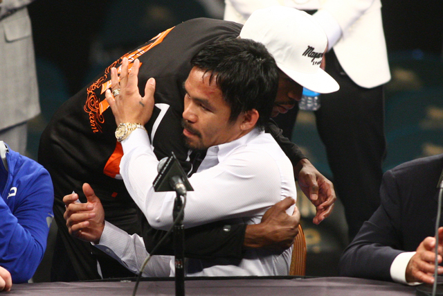 Floyd Mayweather Jr. hugs Manny Pacquiao following Mayweather's unanimous win over Pacquiao in their welterweight unification boxing match at the MGM Grand Garden Arena in Las Vegas on Saturday, M ...