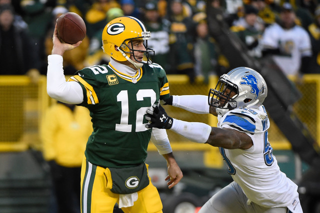Dec 28, 2014; Green Bay, WI, USA;  Green Bay Packers quarterback Aaron Rodgers (12) gets a pass away from Detroit Lions linebacker Tahir Whitehead (59) in the second quarter at Lambeau Field. (Ben ...