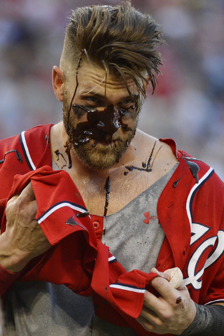 May 9, 2015; Washington, DC, USA;  Washington Nationals right fielder Bryce Harper (34) attempts clean the chocolate off his face during after the game against the Atlanta Braves during a post gam ...