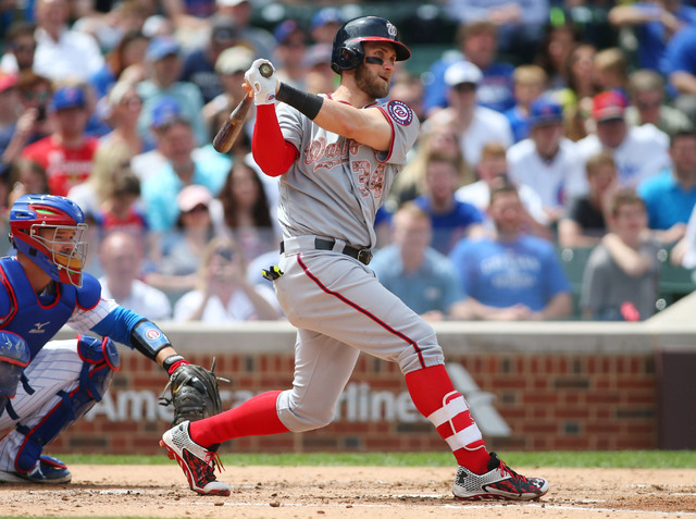 May 25, 2015; Chicago, IL, USA; Washington Nationals right fielder Bryce Harper (34) hits a double during the fourth inning against the Chicago Cubs at Wrigley Field. (Caylor Arnold-USA TODAY Sports)