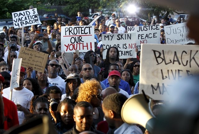 Protestors listen during a rally against what demonstrators call police brutality in McKinney, Texas June 8, 2015. (REUTERS/Mike Stone)