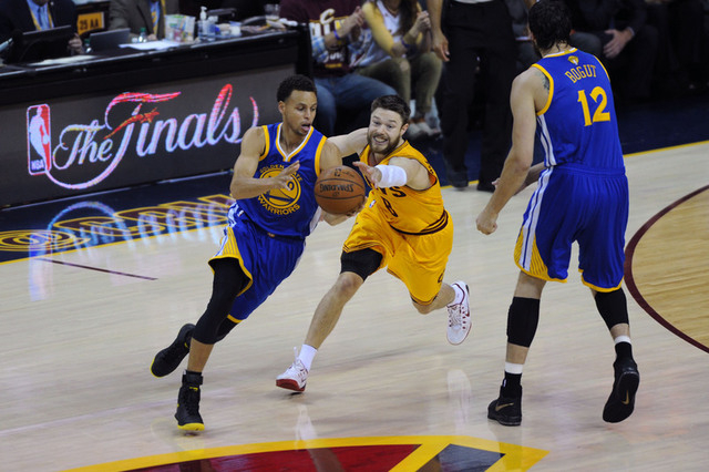 Jun 9, 2015; Cleveland, OH, USA; Golden State Warriors guard Stephen Curry (30) controls the ball against Cleveland Cavaliers guard Matthew Dellavedova (8) during the first quarter of game three o ...