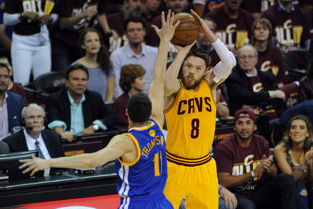Jun 9, 2015; Cleveland, OH, USA; Cleveland Cavaliers guard Matthew Dellavedova (8) shoots against Golden State Warriors guard Klay Thompson (11) during the first quarter of game three of the NBA F ...