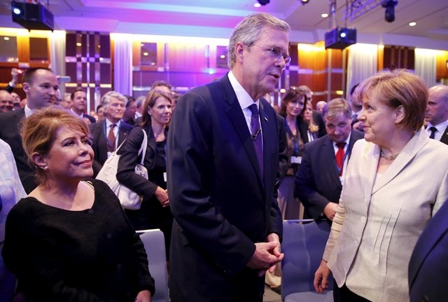 German Chancellor Angela Merkel (R) talks to former Florida Governor and potential Republican presidential candidate Jeb Bush (C) and his wife Columba (L) after he addressed the Christian Democrat ...