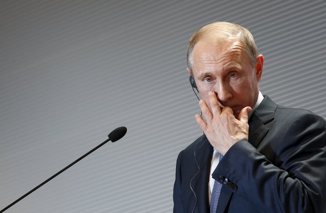 Russian President Vladimir Putin gestures during a joint news conference with Italian Prime Minister Matteo Renzi at the end of a meeting in Milan, northern Italy, June 10, 2015. The Russian leade ...
