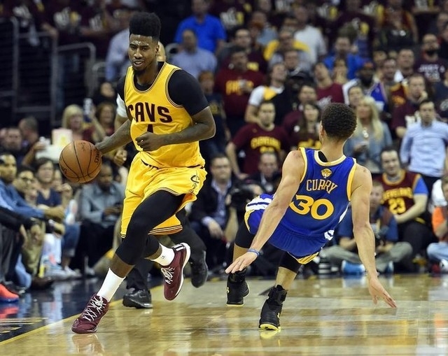 Jun 9, 2015; Cleveland, OH, USA; Cleveland Cavaliers guard Iman Shumpert (4) brings the ball up court against Golden State Warriors guard Stephen Curry (30) during the third quarter in game three  ...