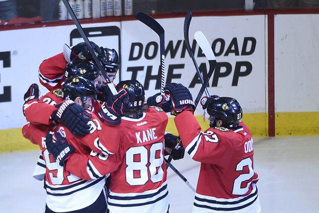 Jun 10, 2015; Chicago, IL, USA; Chicago Blackhawks left wing Brandon Saad (20) is congratulated by teammates after scoring a goal against the Tampa Bay Lightning in the third period in game four o ...