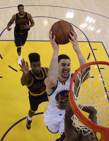 Jun 14, 2015; Oakland, CA, USA; Golden State Warriors guard Klay Thompson (11) shoots the ball against Cleveland Cavaliers guard J.R. Smith (5) in game five of the NBA Finals at Oracle Arena. (Ezr ...