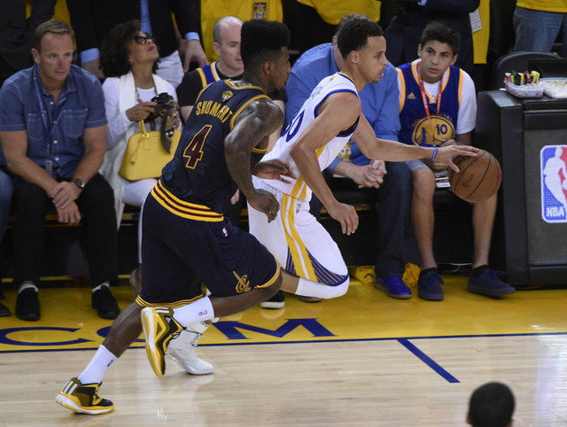 June 14, 2015; Oakland, CA, USA; Golden State Warriors guard Stephen Curry (30) moves the ball ahead of Cleveland Cavaliers guard Iman Shumpert (4) in the second half in game five of the NBA Final ...