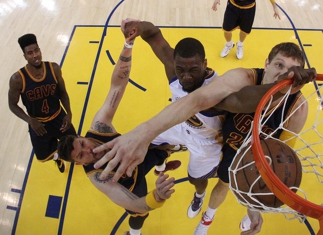 Jun 14, 2015; Oakland, CA, USA; Golden State Warriors forward Harrison Barnes (40) dunks the ball over Cleveland Cavaliers guard Mike Miller (18) and center Timofey Mozgov (20) in game five of the ...