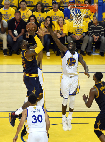 Jun 14, 2015; Oakland, CA, USA; Cleveland Cavaliers forward LeBron James (23) shoots the ball against Golden State Warriors forward Draymond Green (23) in game five of the NBA Finals at Oracle Are ...