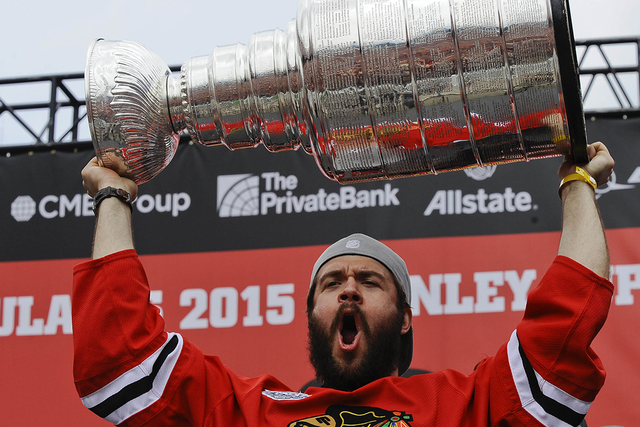 Jun 18, 2015; Chicago, IL, USA; Chicago Blackhawks defenseman Brent Seabrook (7) yells after he kissed the Stanley Cup trophy during the 2015 Stanley Cup championship rally at Soldier Field. (Mat ...