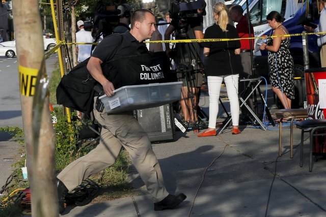 An investigator arrives at the Emanuel African Methodist Episcopal Church in Charleston, South Carolina, June 19, 2015, two days after a mass shooting left nine dead during a bible study at the ch ...