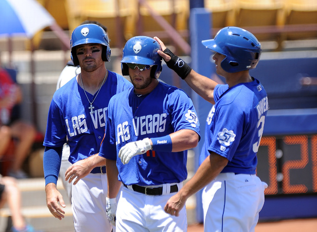 Las Vegas 51s catcher Dan Rohlfing is congratulated by T.J. Rivera, right, and Jayce Boyd after hitting a three run home run in the third inning of their Triple-A minor league baseball game agains ...
