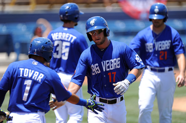 Las Vegas 51s catcher Dan Rohlfing is congratulated by Wifredo Tovar after hitting a three run home run in the third inning of their Triple-A minor league baseball game against the Reno Aces at Ca ...