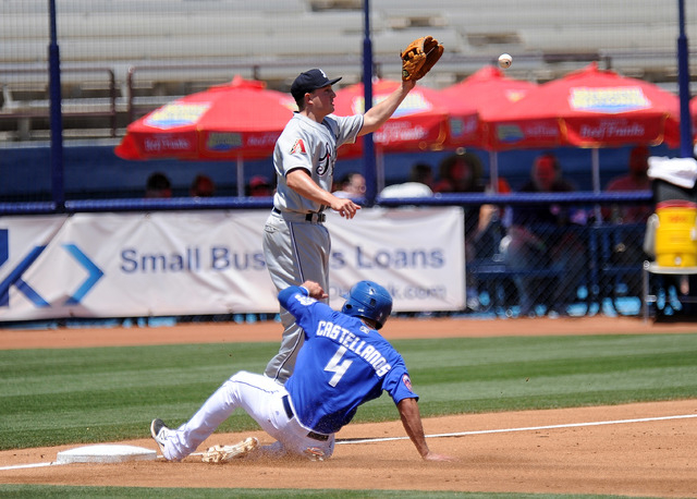 Las Vegas 51s base runner Alex Castellanos advances safely to third base on a fly ball as Reno Aces third baseman Jordan Pacheco fields the throw in the second inning of their Triple-A minor leagu ...
