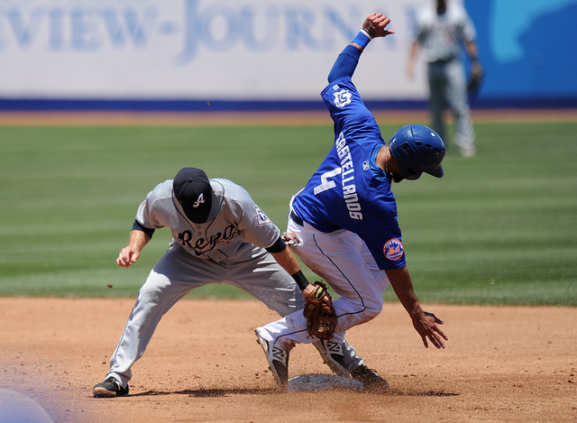 Las Vegas 51s base runner Alex Castellanos steals second base while Reno Aces second baseman Michael Freeman applies the tag in the third inning of their Triple-A minor league baseball game at Cas ...