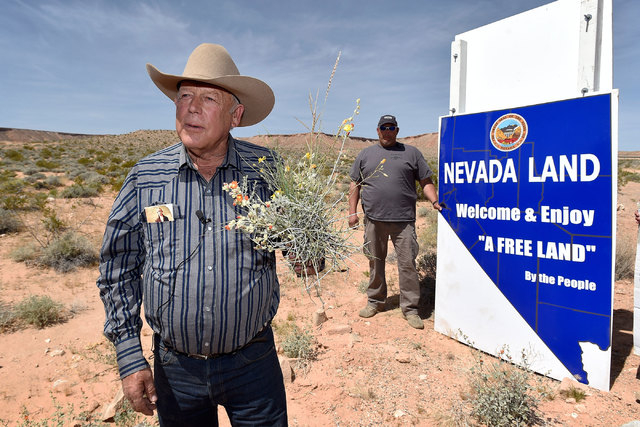 Rancher Cliven Bundy displays a bouquet of desert foliage that his cattle grazes on during a news conference at an event near his ranch in Bunkerville on Saturday, April 11, 2015.  Bundy is hostin ...