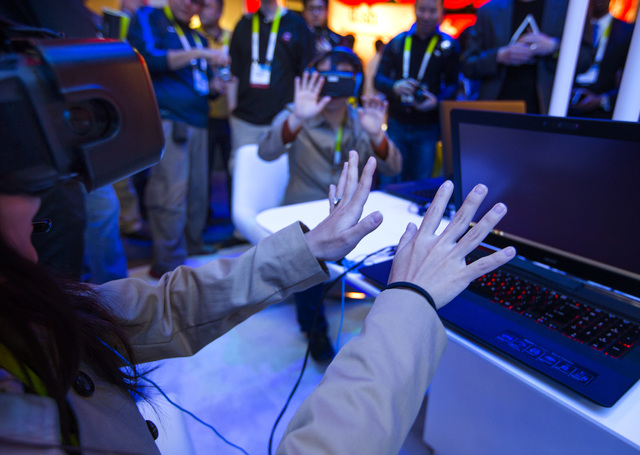 People interact with the Intel virtual reality demonstration Tuesday, Jan. 6, 2015 during Consumer Electronic Show in the Las Vegas Convention Center. Around 160,000 people with 25% coming from ...